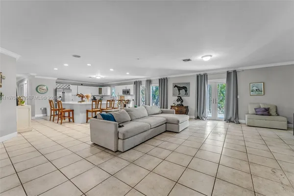 a living room with furniture a computer and a table