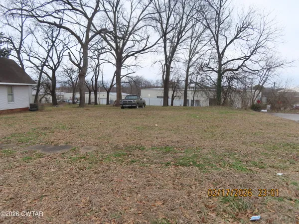 a backyard of a house with large trees