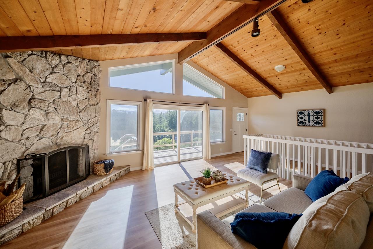 155 Rabbits Run Road Santa Cruz, CA 95060 - Photo 20 of 113 a living room with furniture a fireplace and a floor to ceiling window