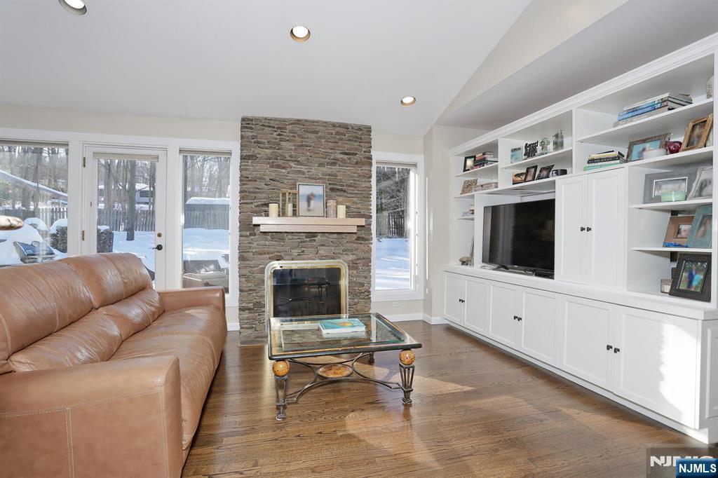 28 Bear Mountain Road Ringwood, NJ 07456 - Photo 16 of 50 a living room with furniture a flat screen tv and a fireplace
