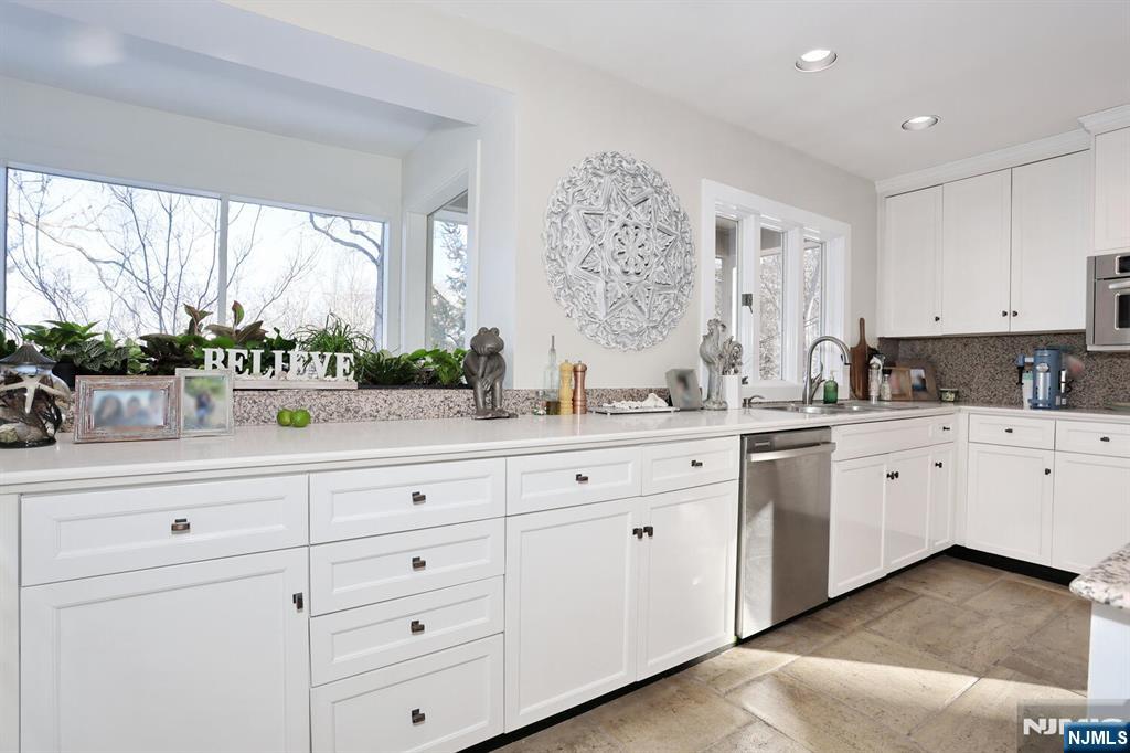 28 Bear Mountain Road Ringwood, NJ 07456 - Photo 18 of 50 a kitchen with stainless steel appliances white cabinets and a large window