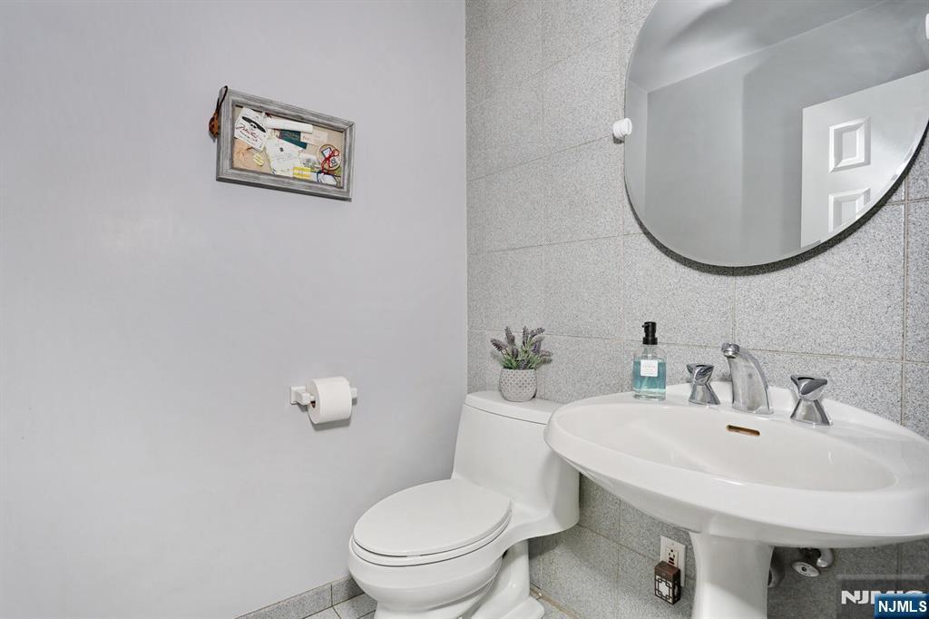 28 Bear Mountain Road Ringwood, NJ 07456 - Photo 26 of 50 a bathroom with a toilet a sink and mirror