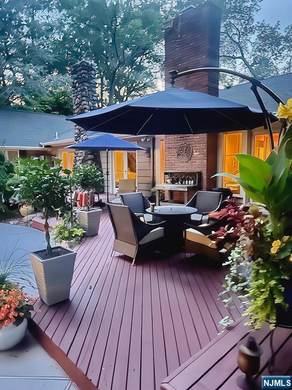 28 Bear Mountain Road Ringwood, NJ 07456 - Photo 42 of 50 a view of a patio with couches chairs potted plants and a yard