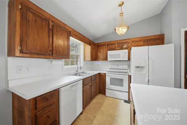 a kitchen with stainless steel appliances a sink stove and refrigerator