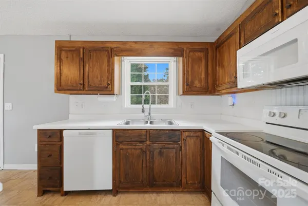 a kitchen with a sink cabinets and window