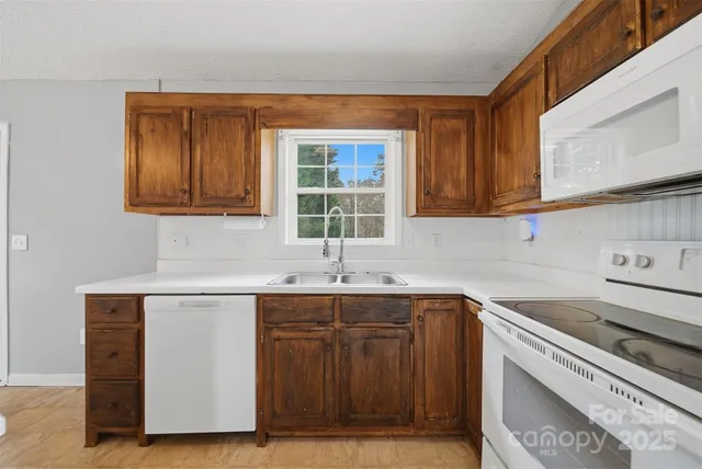 a kitchen with a sink cabinets and window