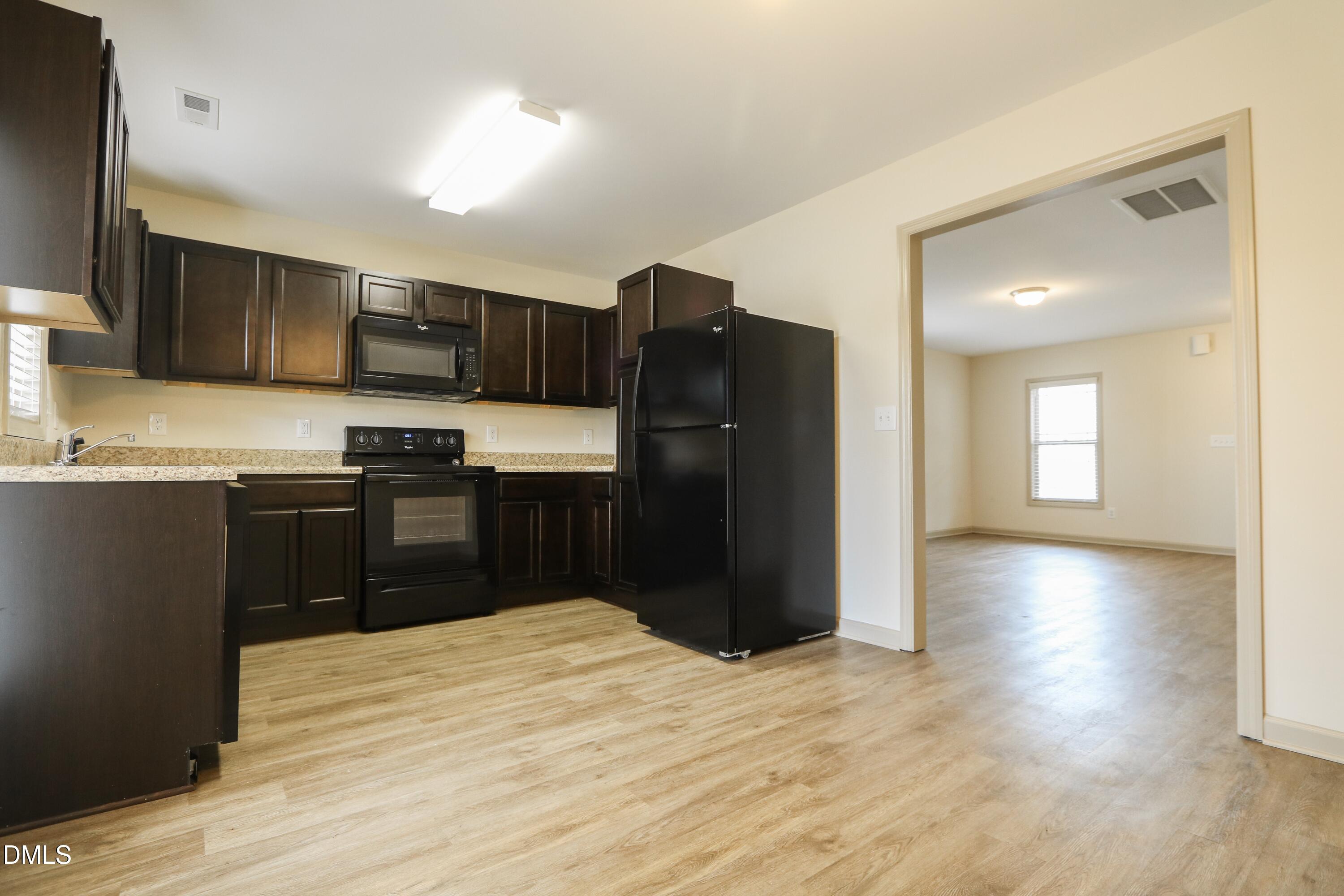 175 Carvins Cove Clayton, NC 27520 - Photo 2 of 10 a kitchen with stainless steel appliances granite countertop a refrigerator and a sink
