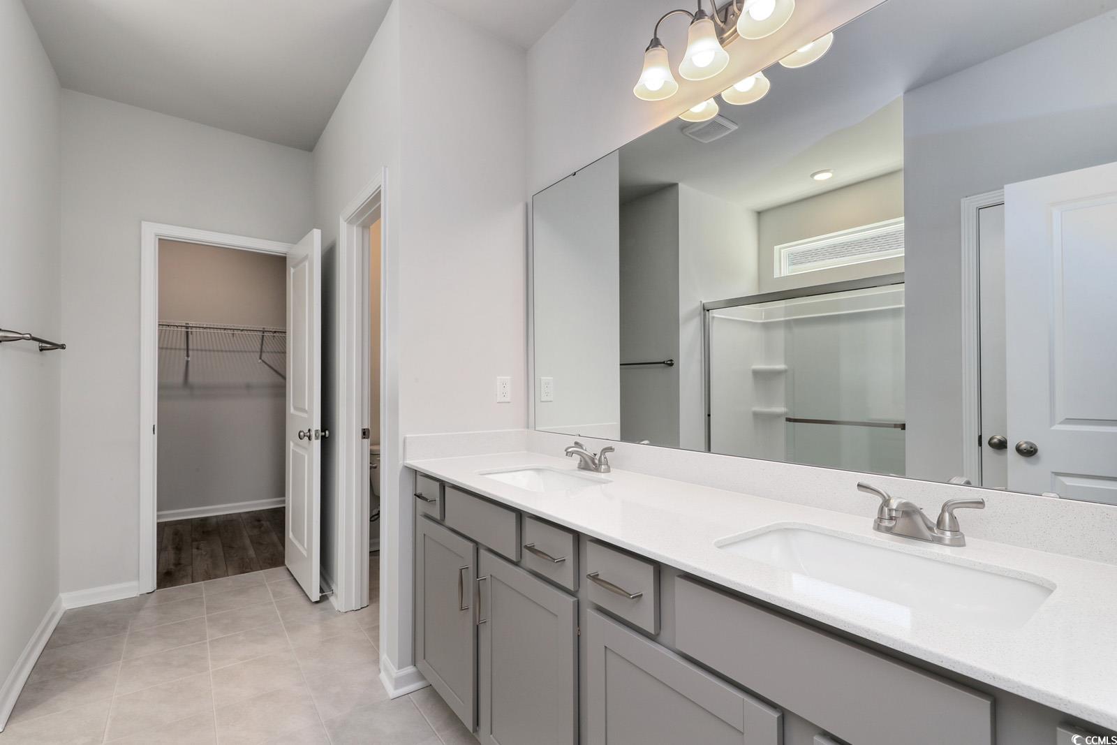 331 Garden Grove Street Conway, SC 29526 - Photo 12 of 24 Full bathroom with a spacious closet, a shower stall, double vanity, and light tile patterned floors