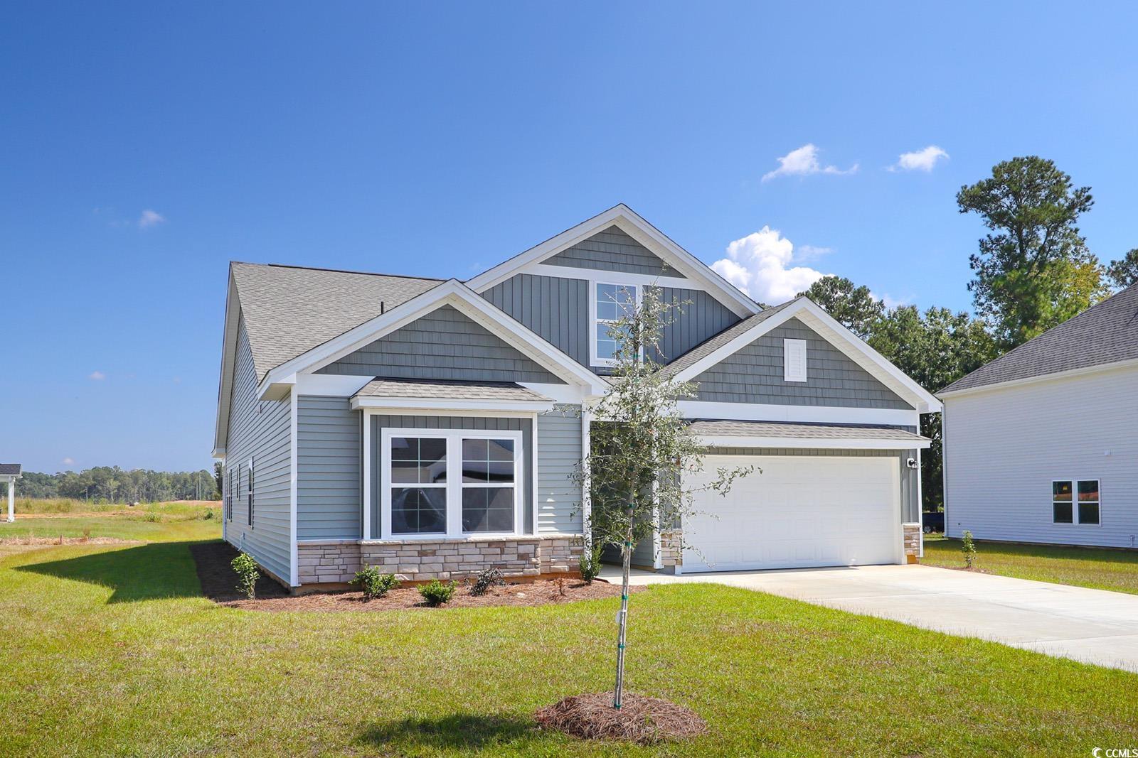 331 Garden Grove Street Conway, SC 29526 - Photo 2 of 24 Craftsman inspired home with stone siding, a front lawn, driveway, and board and batten siding