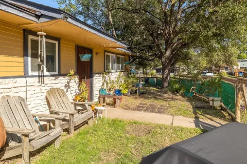 a view of a patio with table and chairs with wooden fence and plants
