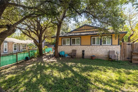 a front view of a house with a yard table and chairs