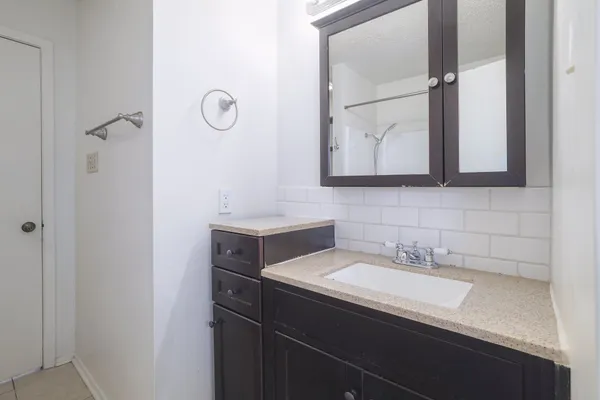 a bathroom with a sink and a mirror