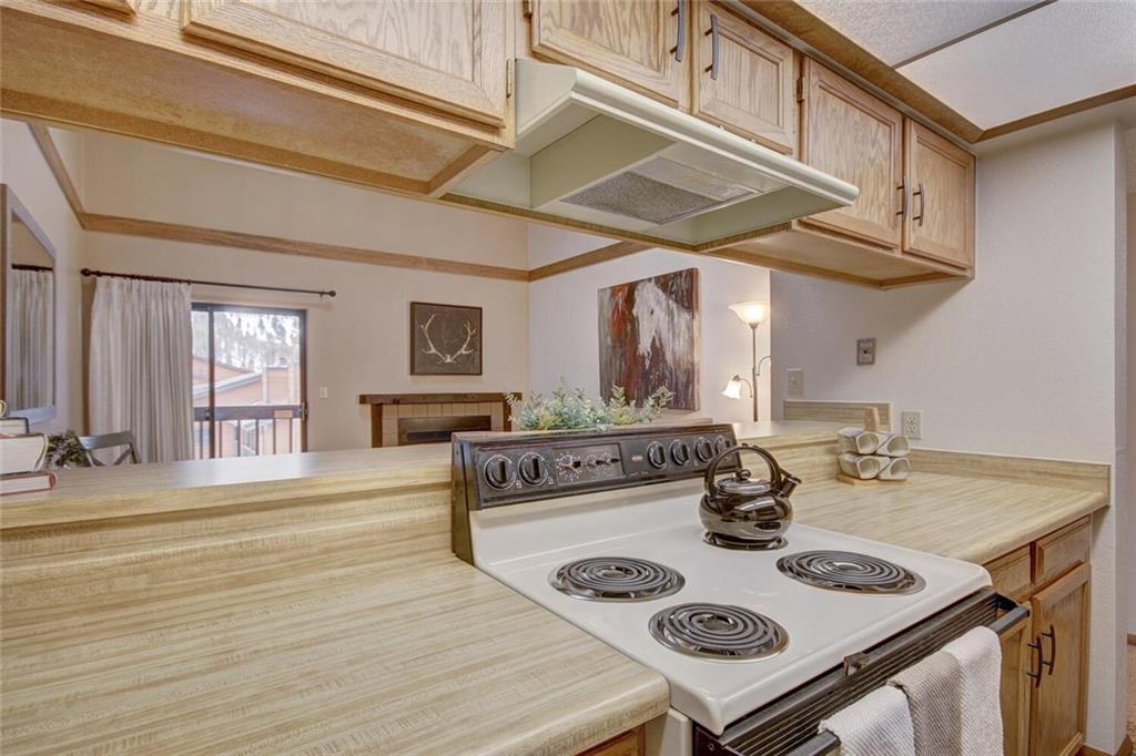 500 Bills Ranch Road, Unit 321 Frisco, CO 80443 - Photo 12 of 27 a kitchen with a table chairs and a stove top oven