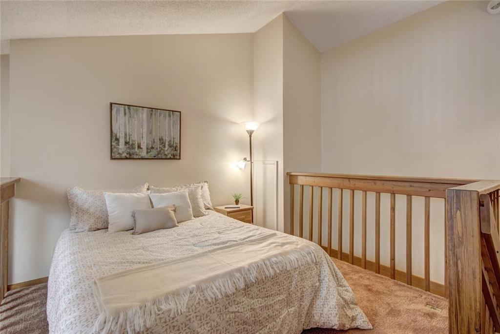 500 Bills Ranch Road, Unit 321 Frisco, CO 80443 - Photo 14 of 27 a bedroom with a bed and a night stand