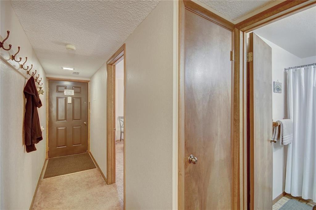 500 Bills Ranch Road, Unit 321 Frisco, CO 80443 - Photo 17 of 27 a hallway with white doors wooden floor and stairs
