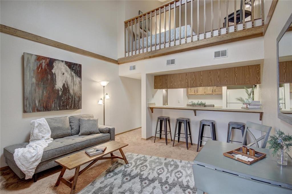 500 Bills Ranch Road, Unit 321 Frisco, CO 80443 - Photo 3 of 27 a living room with furniture a rug and kitchen view