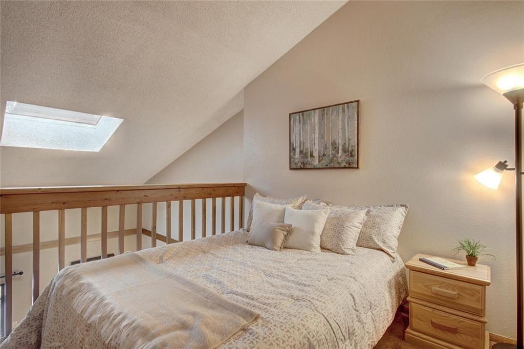 500 Bills Ranch Road, Unit 321 Frisco, CO 80443 - Photo 5 of 27 a large bed sitting in a bedroom next to a window