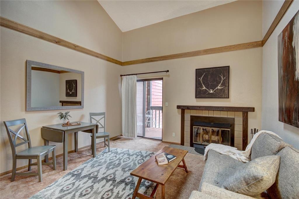 500 Bills Ranch Road, Unit 321 Frisco, CO 80443 - Photo 9 of 27 a living room with furniture a window and a fireplace
