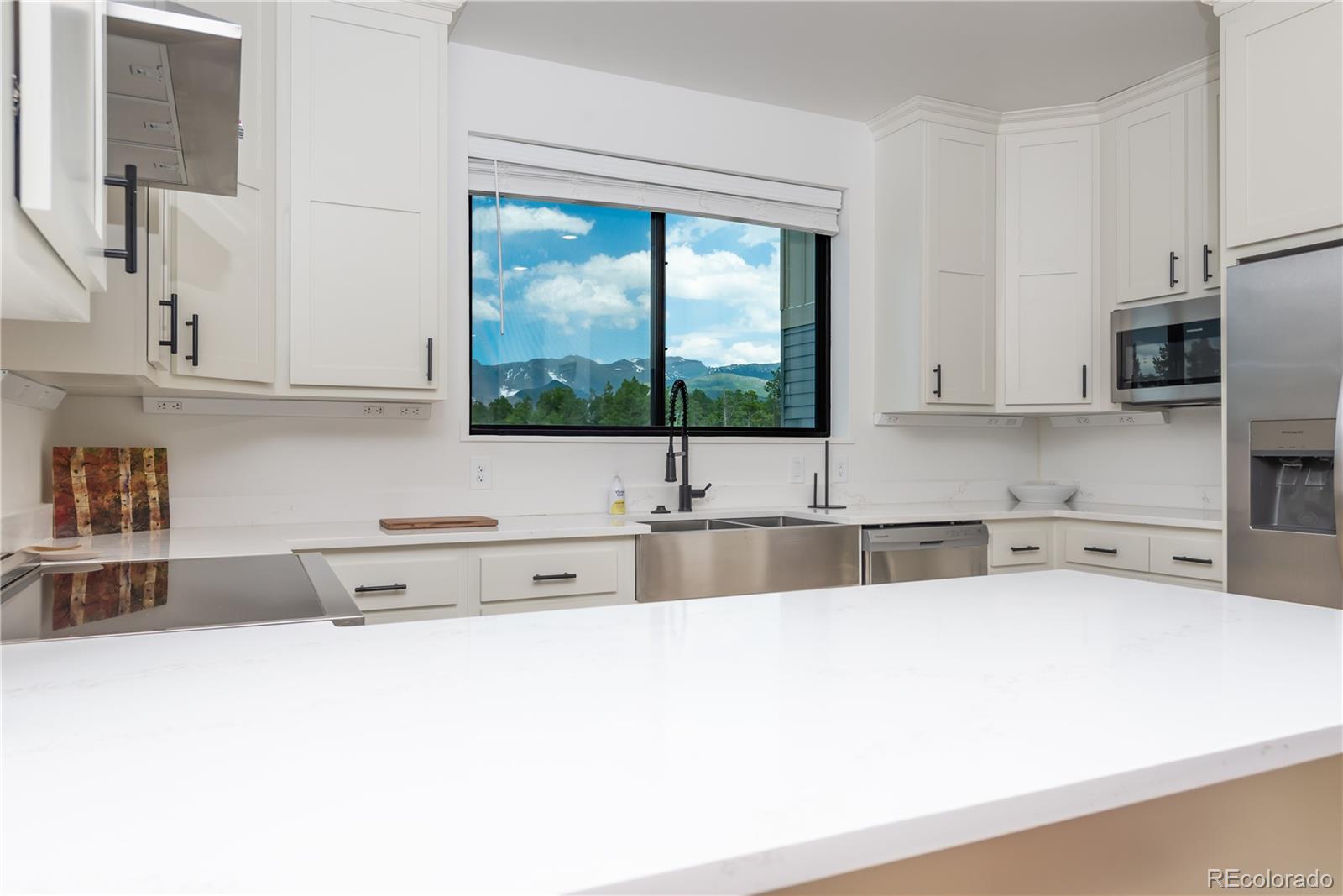 853 Ferret Lane Fraser, CO 80442 - Photo 13 of 32 a kitchen with stainless steel appliances a sink a stove and a microwave