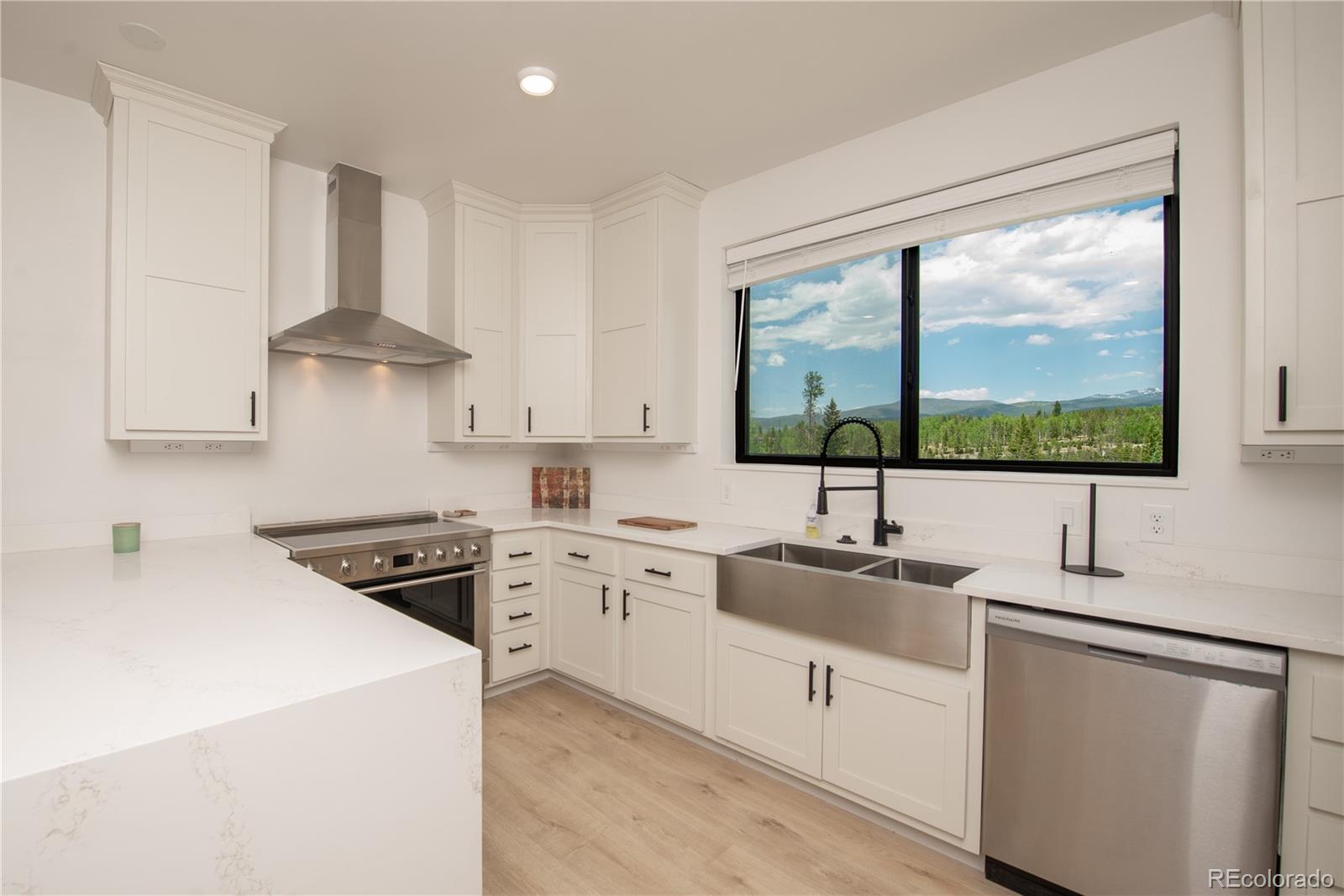 853 Ferret Lane Fraser, CO 80442 - Photo 14 of 32 a kitchen with a sink stove and cabinets