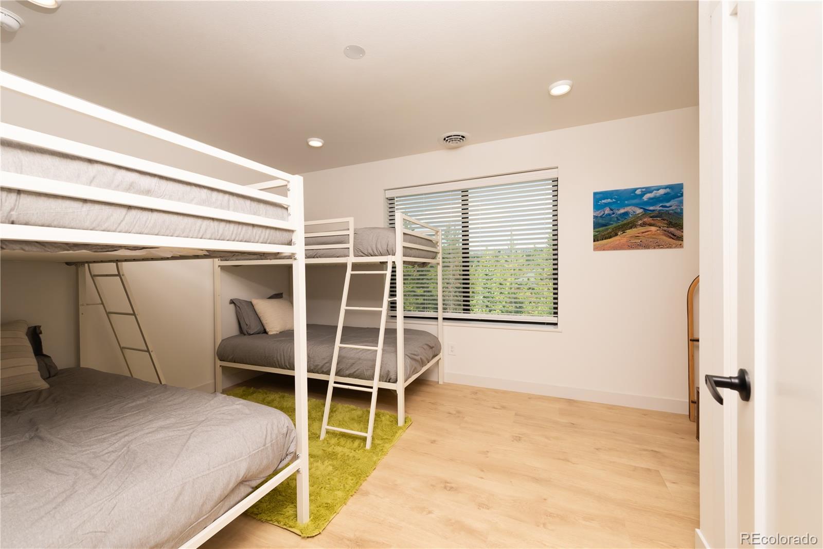 853 Ferret Lane Fraser, CO 80442 - Photo 27 of 32 a bedroom with a bed and a window