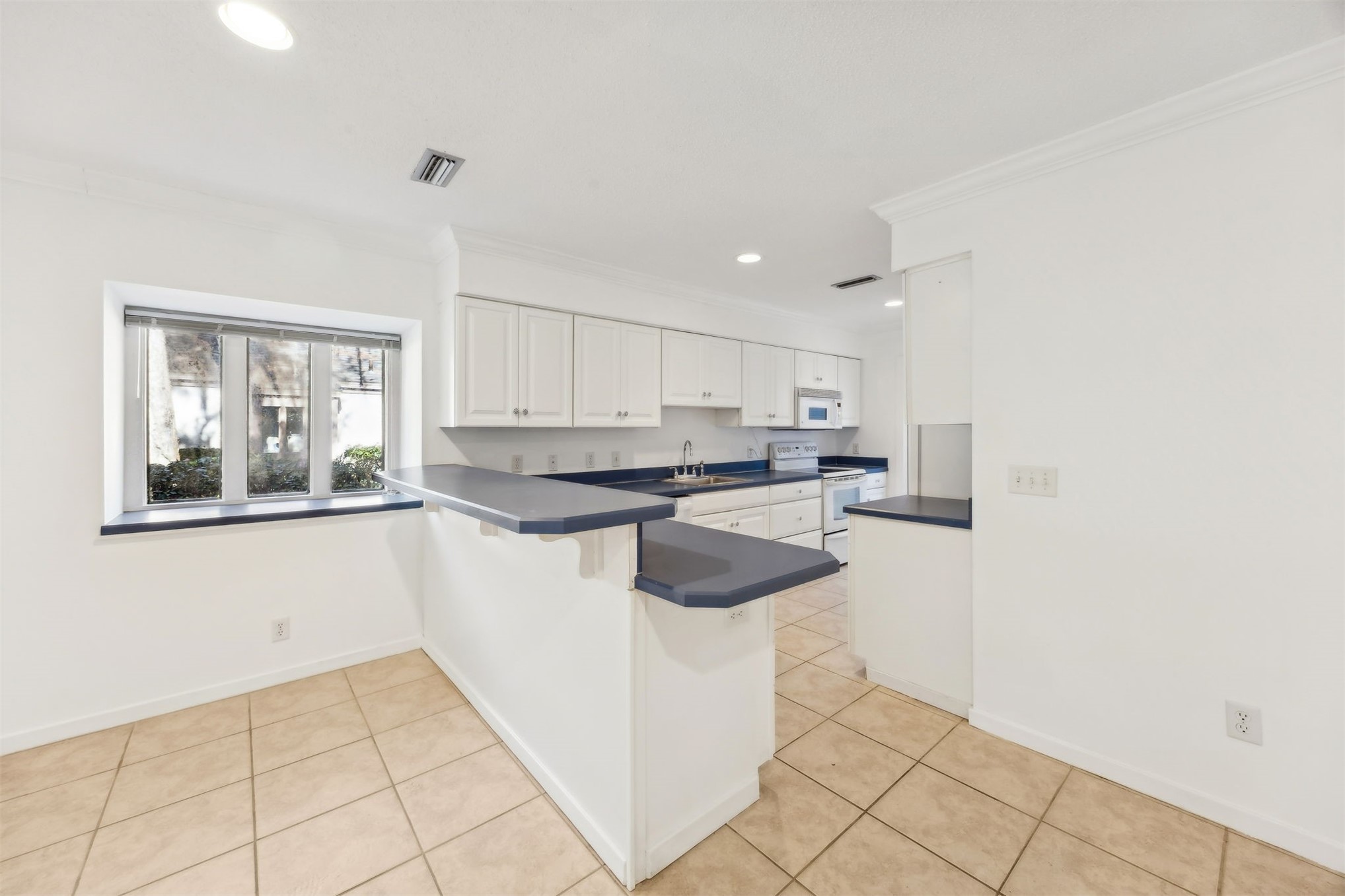 3207 Sea Marsh Road Fernandina Beach, FL 32034 - Photo 10 of 37 a kitchen with a sink a counter top space and cabinets