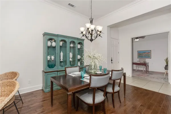 a view of a dining room with furniture wooden floor and chandelier