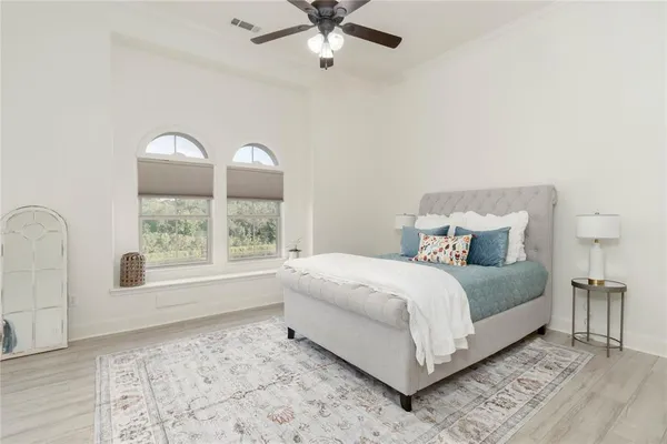 a bedroom with a large bed and a window