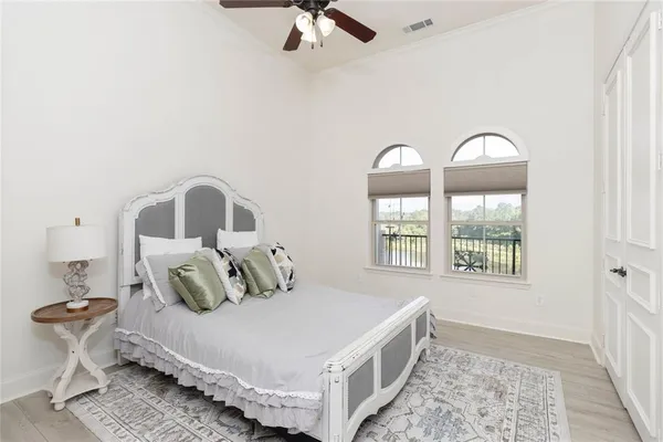 a bedroom with a bed and a large window