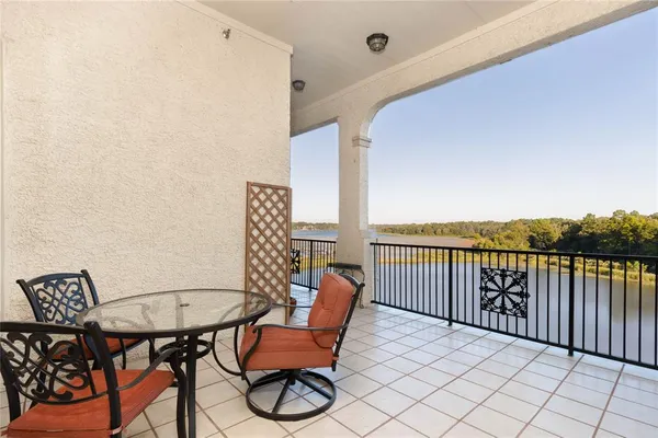 a balcony with table and chairs