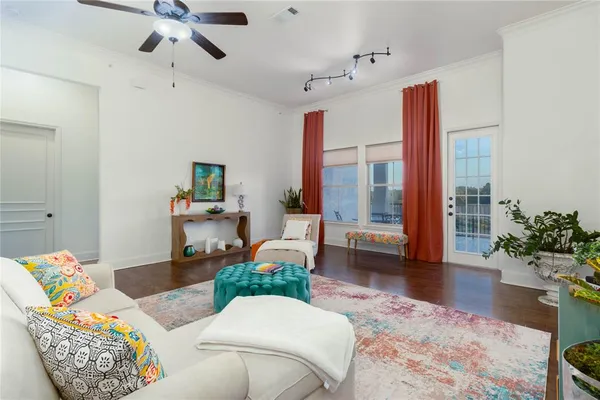 a living room with furniture and wooden floor