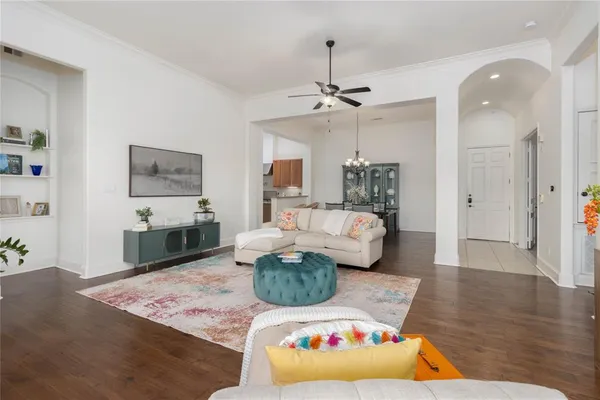 a living room with furniture and a wooden floor