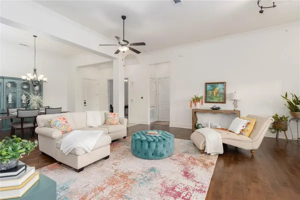 a living room with furniture ceiling fan and a rug