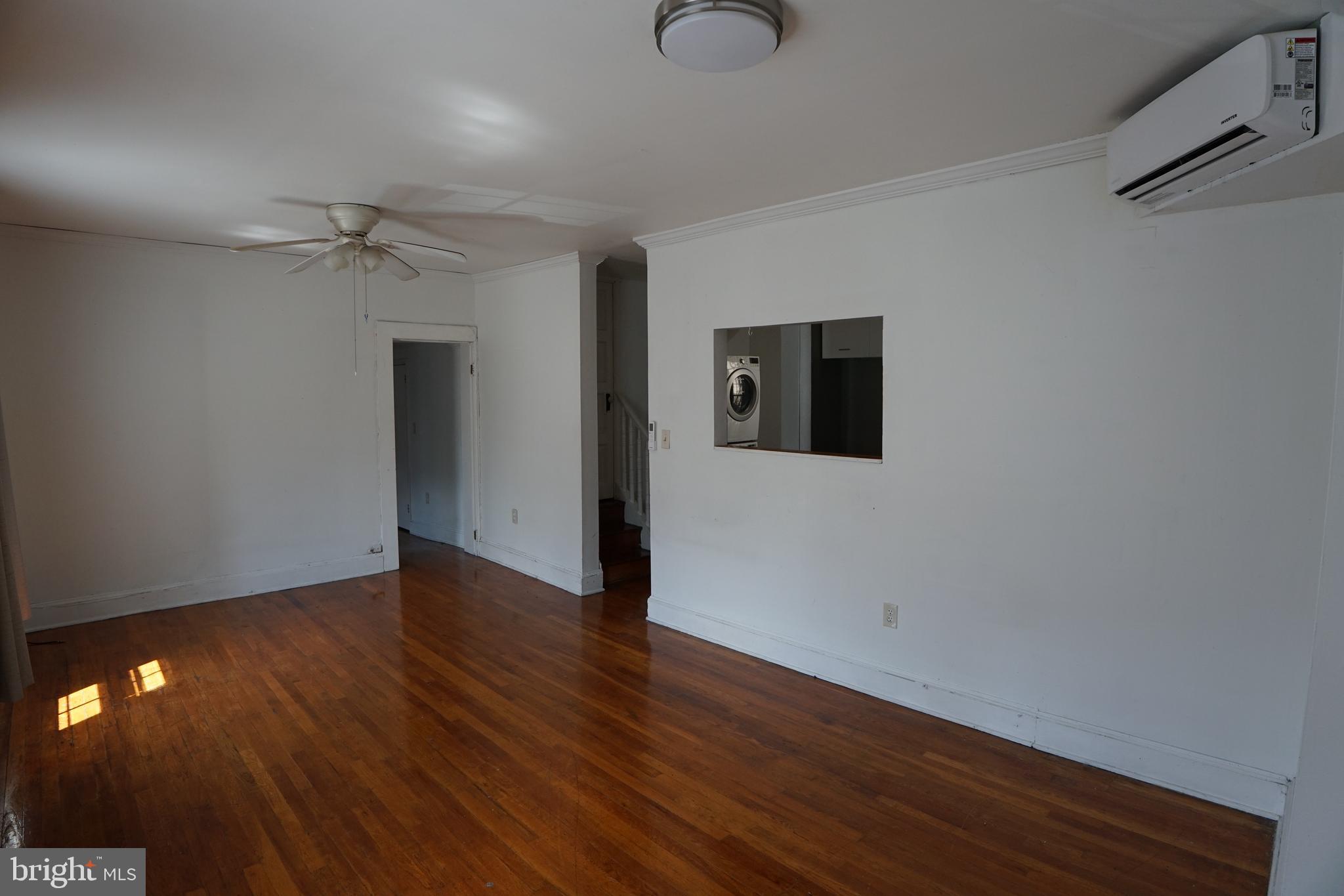 802 Cathedral Street, Unit 4 Baltimore, MD 21201 - Photo 2 of 15 wooden floor in an empty room with a window