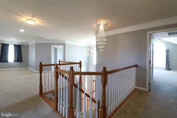 a view of a hallway with stairs