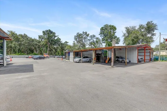 a living room with stainless steel appliances furniture and a flat screen tv