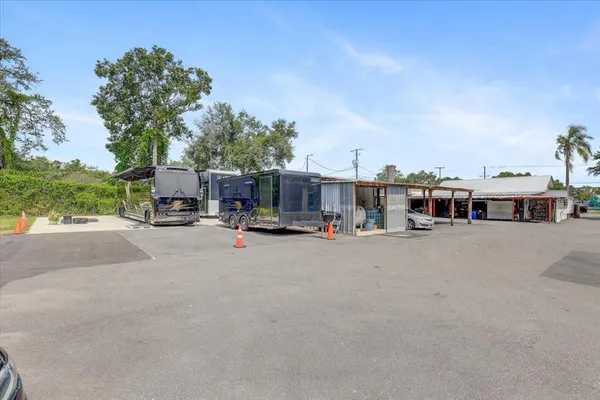 a room with a table chairs and wooden floor
