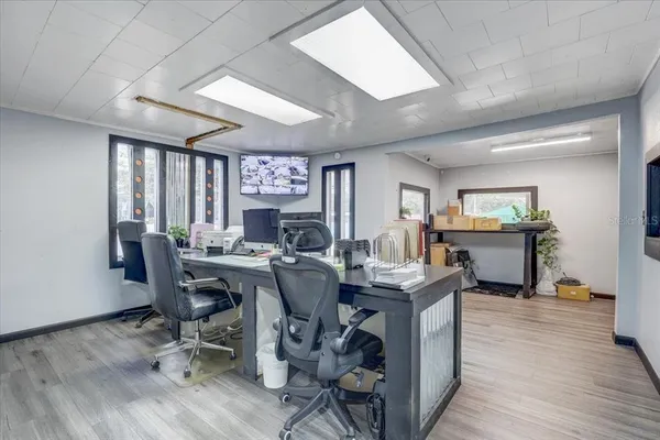 a view of a hallway with bathroom and wooden floor