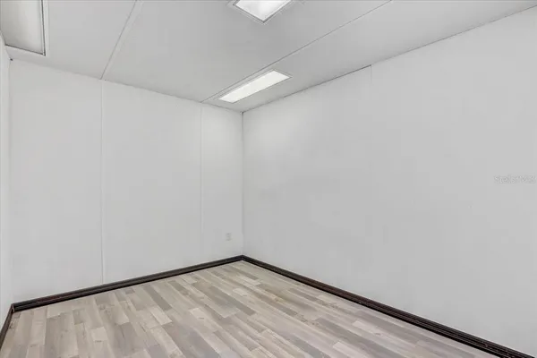 an aerial view of residential houses with outdoor space and parking