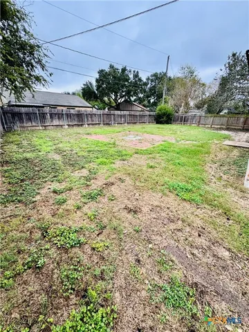 a view of a swimming pool with a yard