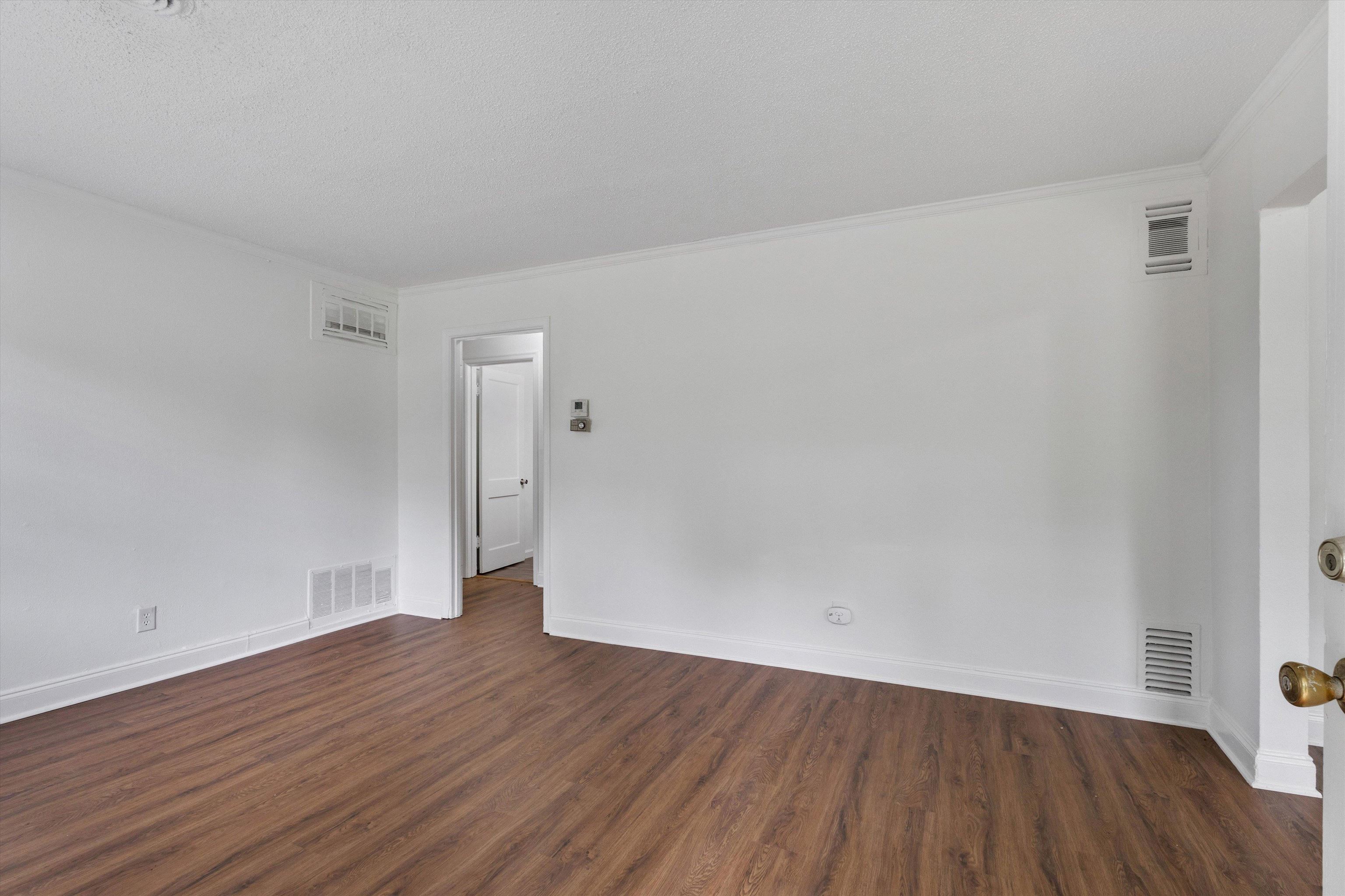 4565 Verne Road Memphis, TN 38117 - Photo 3 of 18 Spacious room featuring wood-finish flooring, white walls, and crown molding