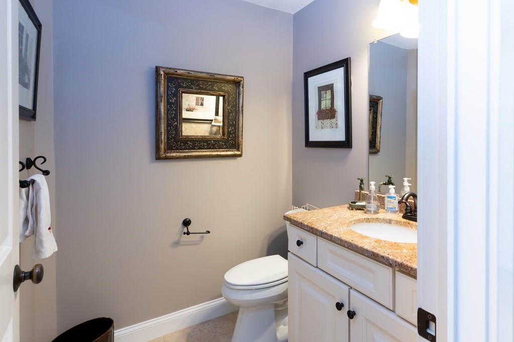 6 North Street Mashpee, MA 02649 - Photo 11 of 22 a bathroom with a toilet sink and mirror