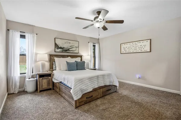 a spacious bedroom with a bed and window