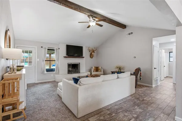 a living room with furniture a fireplace and a flat screen tv