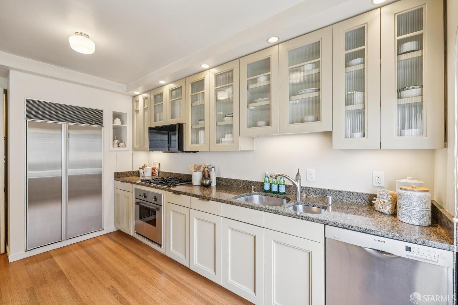 2100 Green Street, Unit 206 San Francisco, CA 94123 - Photo 13 of 33 a kitchen with stainless steel appliances granite countertop a sink stove and refrigerator