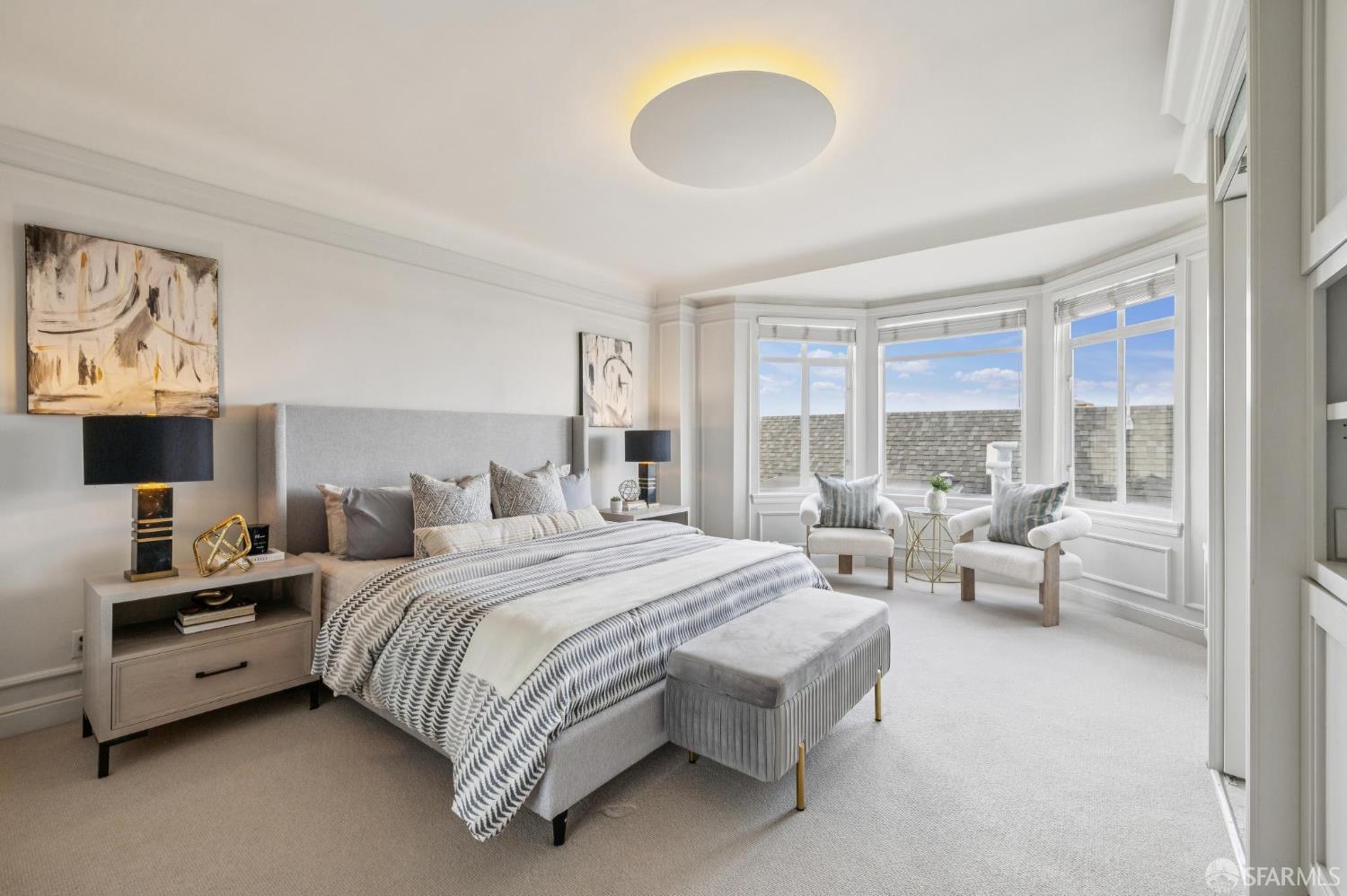 2100 Green Street, Unit 206 San Francisco, CA 94123 - Photo 18 of 33 a spacious bedroom with a bed a couch and large window