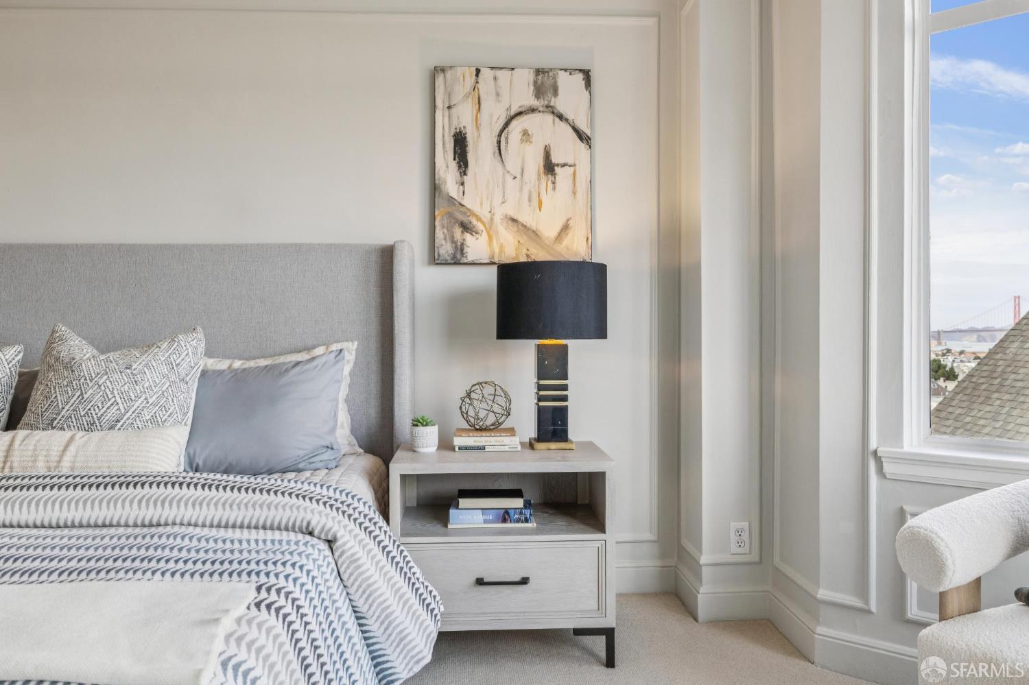 2100 Green Street, Unit 206 San Francisco, CA 94123 - Photo 19 of 33 a bedroom with a bed a mirror and lamp