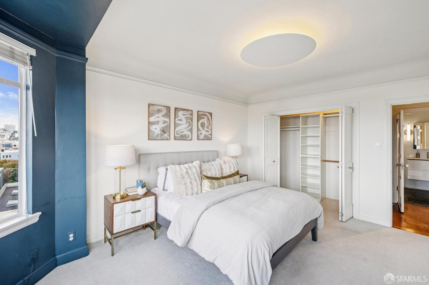 2100 Green Street, Unit 206 San Francisco, CA 94123 - Photo 25 of 33 a bedroom with a bed and a lamp