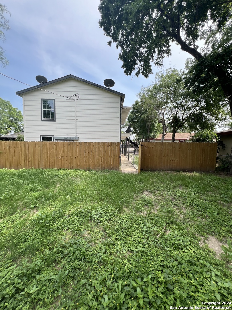 1723 West Mayfield Boulevard, Unit 5 San Antonio, TX 78211 - Photo 11 of 13 a backyard of a house with lots of green space