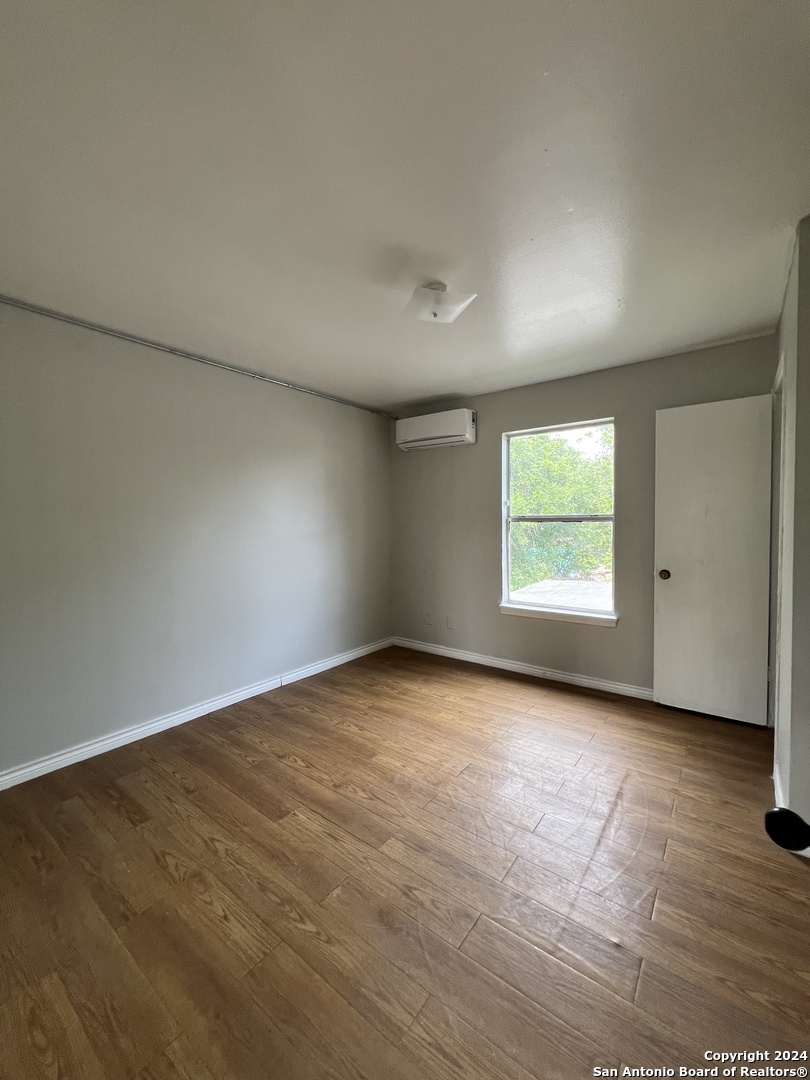 1723 West Mayfield Boulevard, Unit 5 San Antonio, TX 78211 - Photo 6 of 13 an empty room with a window